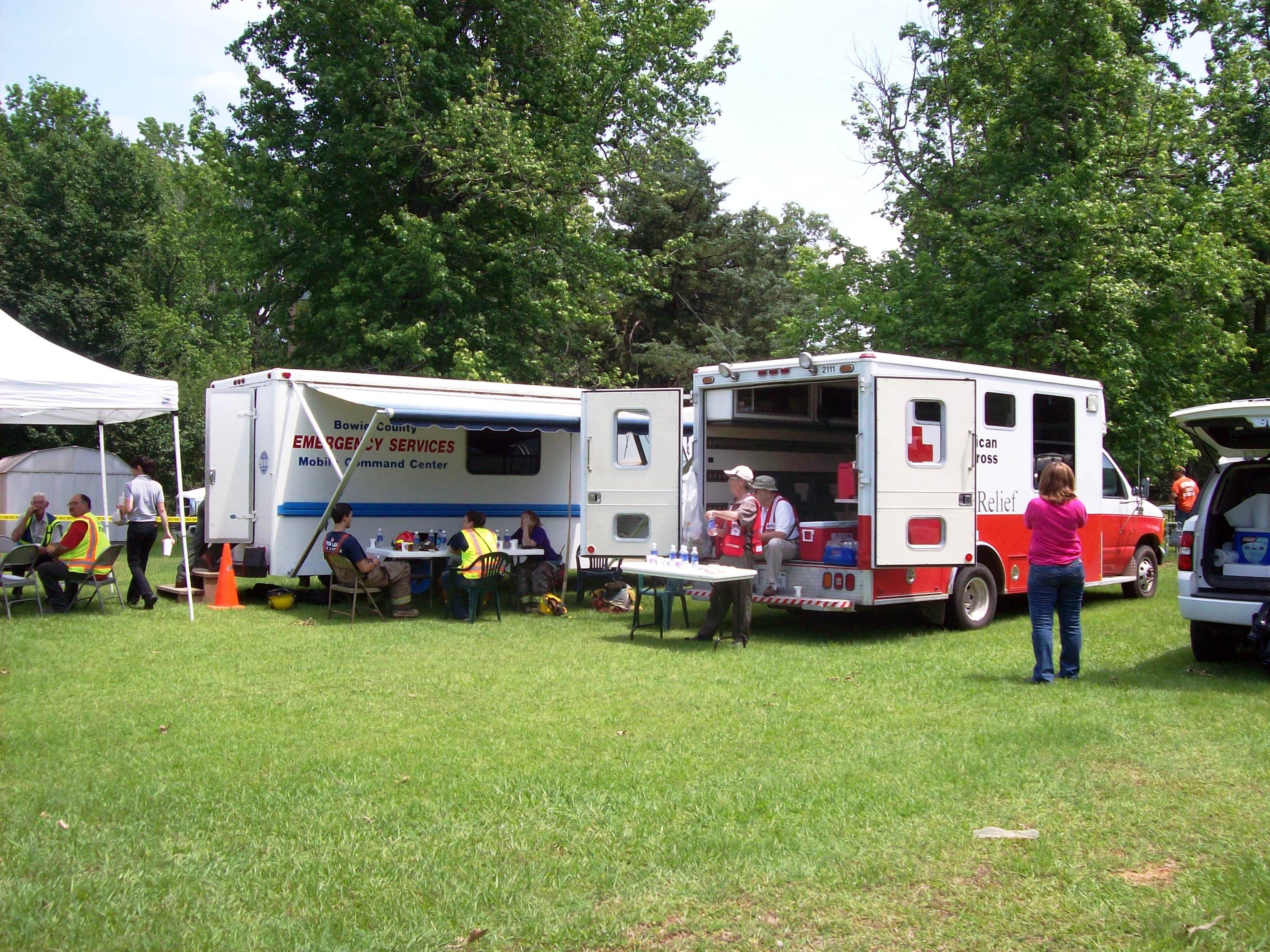 Emergency vehicles, including the Emergency Management vehicle, stand by to provide assistance.